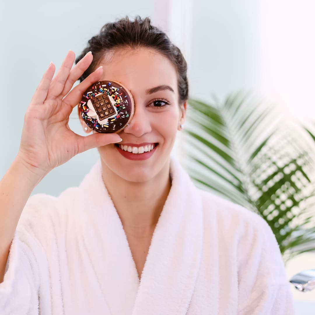 woman holding a chocolate donut soap